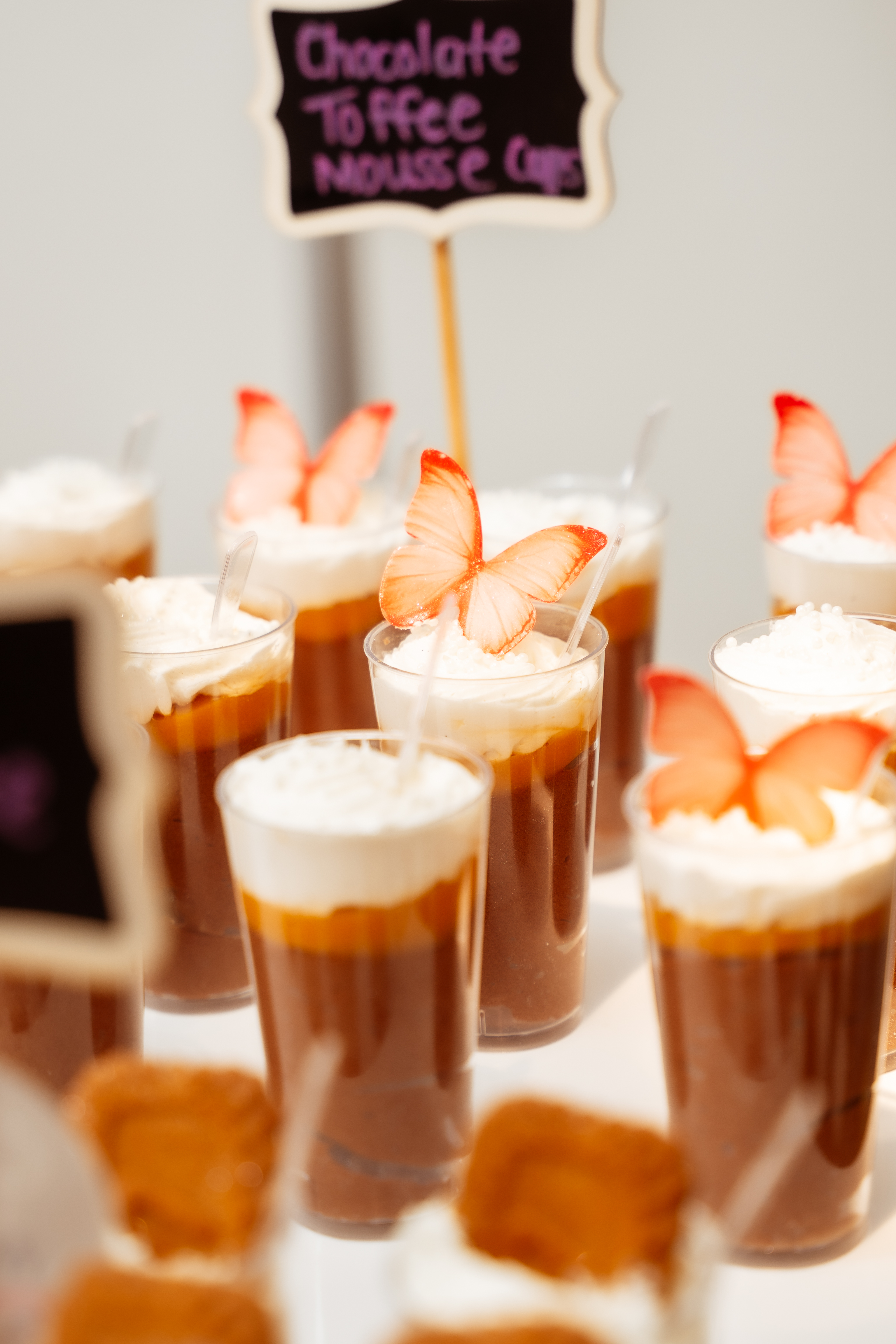 Chocolate toffee mousse cups with butterfly decorations