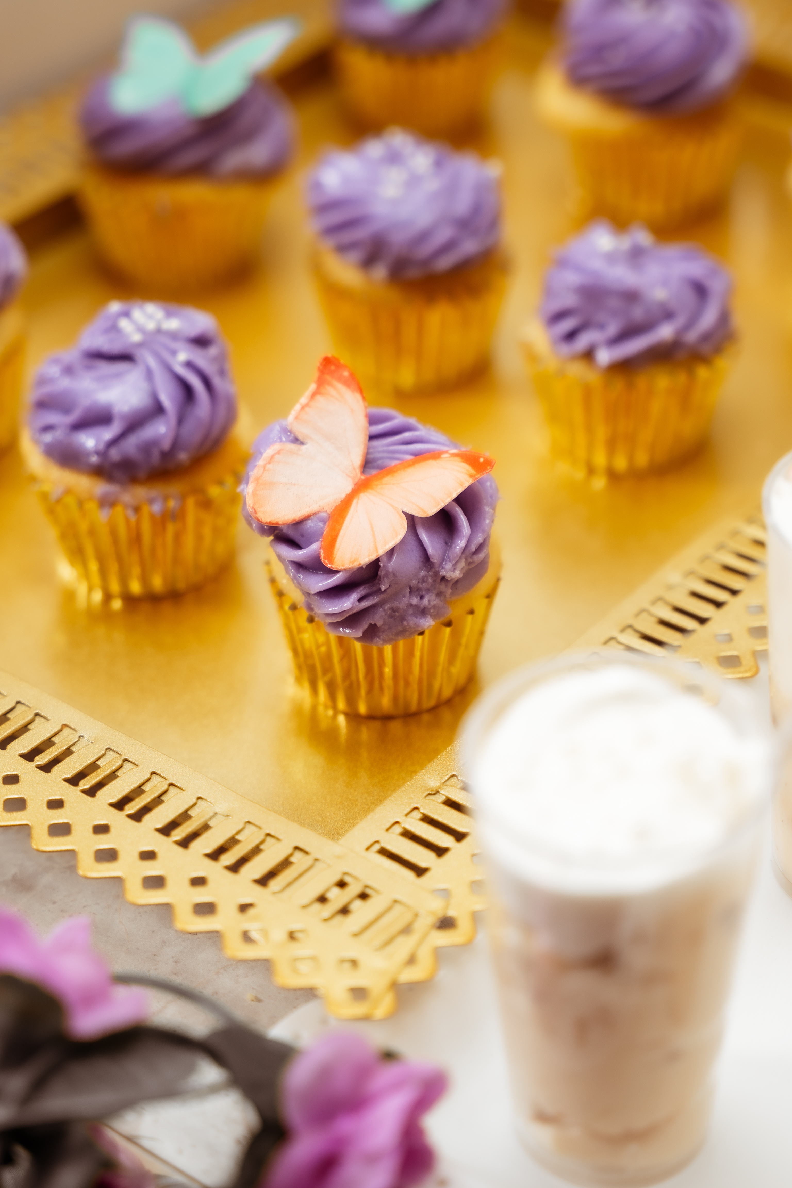 Mini cupcakes with purple frosting and butterfly toppers