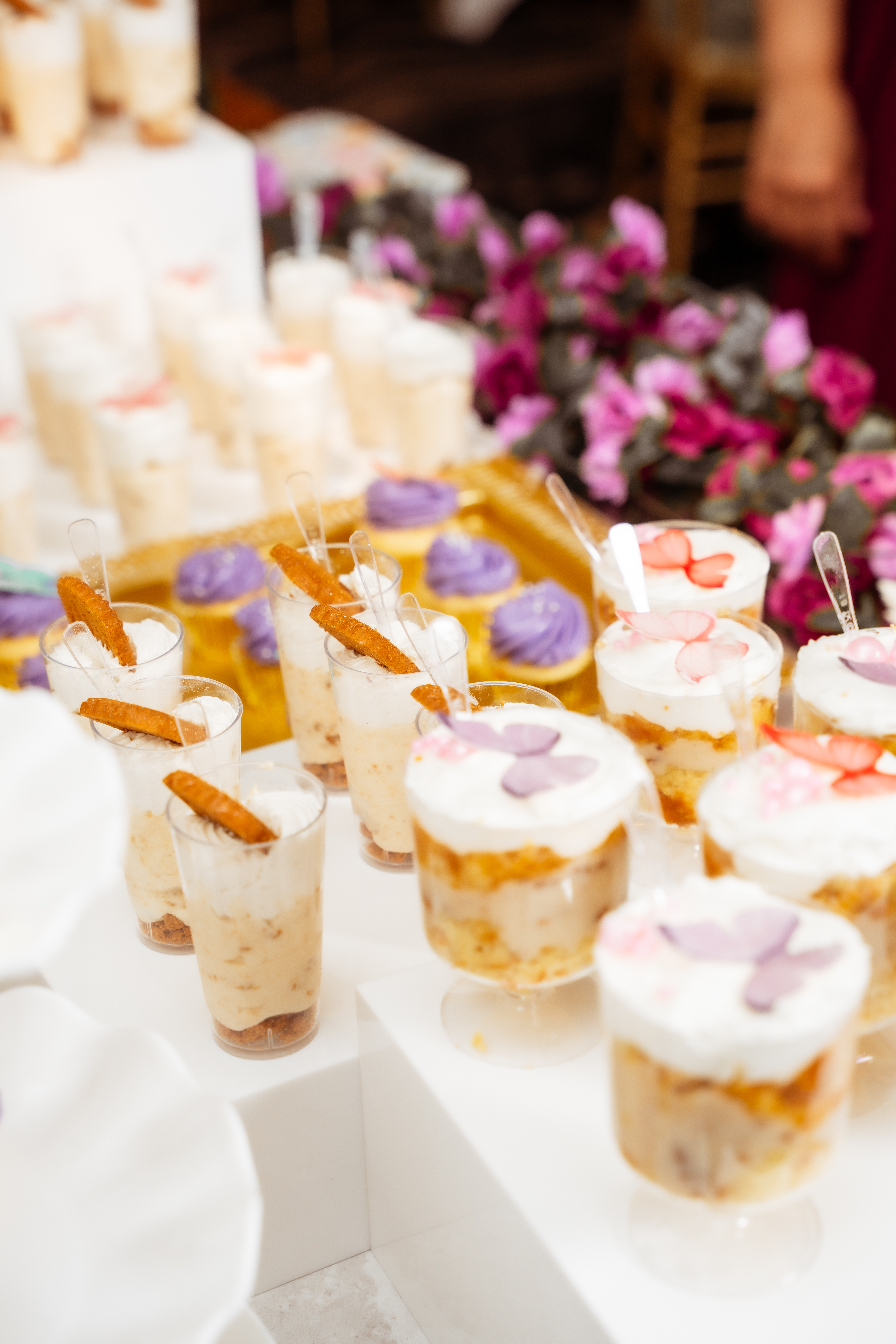 Dessert table with cheesecake cups and mini cupcakes