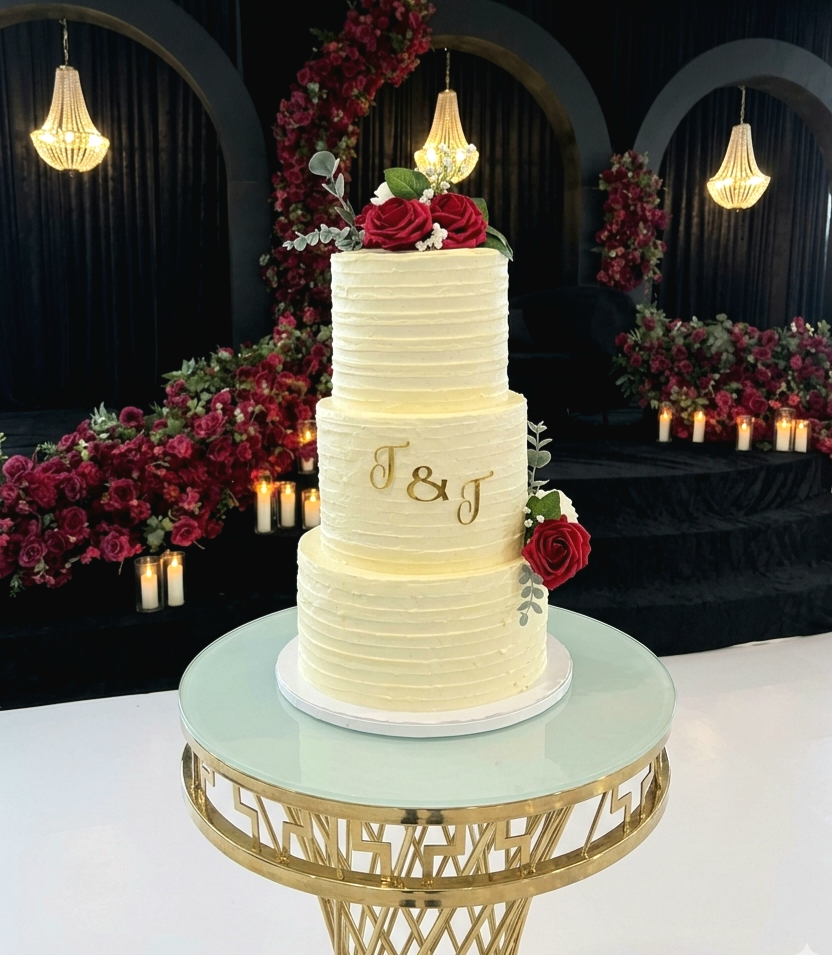 A three-tier Bakes By Jess wedding cake